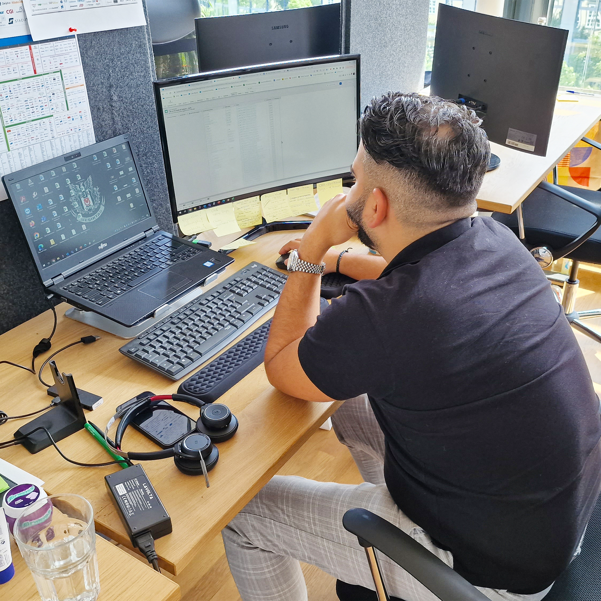 One employee sitting focused behind his screen